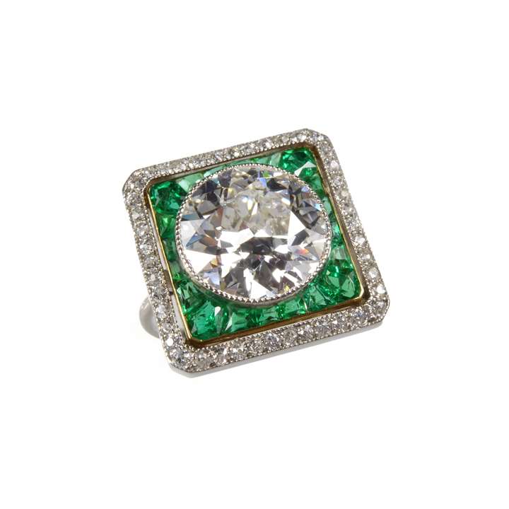 Round brilliant cut diamond, emerald and diamond cluster ring
